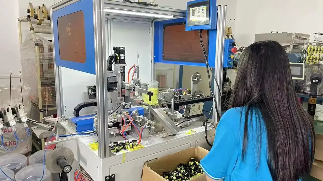 Worker beside production equipment in a workshop
